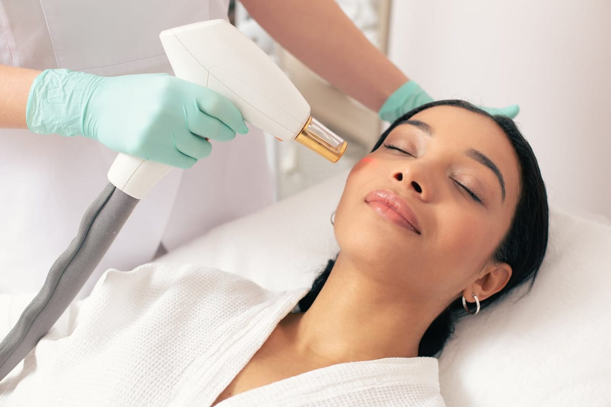 A woman relaxing with her eyes closed during a laser skin treatment
