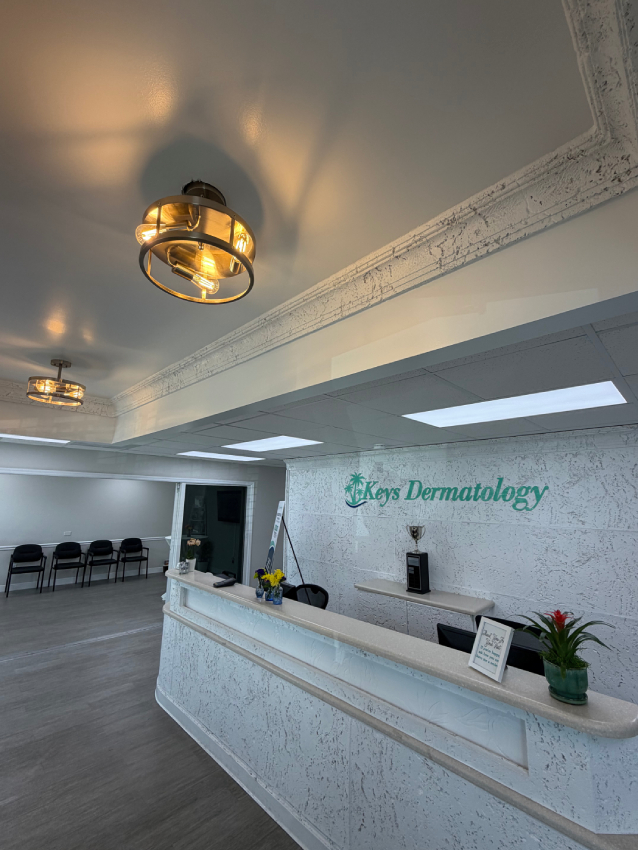 The new Islamorada reception area, with the front desk, waiting-room chairs and a pendant light