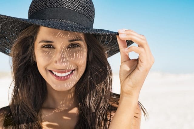 woman wearing hat to protect herself from sun